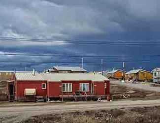 Image of a red house with cloudy sky in Nunavut, Canada
